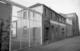 View from S showing part of ESE front of oil and grease works with cabinet works in background