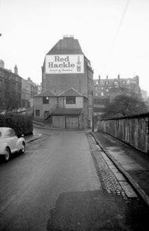 View from SSW showing SSW front of number 39 Otago Street with warehouse and workshops in background