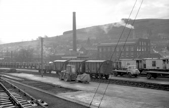 View looking S showing wagons at station with part of mill in background, Galashiels railway station