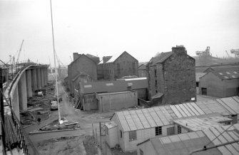 View from NNE showing N and E fronts of numbers 45-49 Cheapside Street with flour mill in background