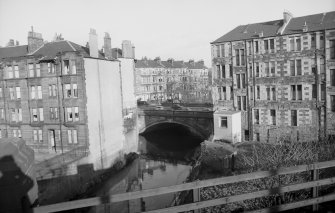 View from W showing WNW front of bridge with tenement on left and part of 254-276 Kilmarnock Road on right