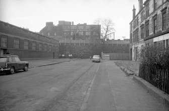 View looking W along Burgh Hall Street with part of tenements on right and building on left with part of printing works in background