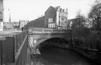 View from SW showing SSW front of bridge with tenement in background