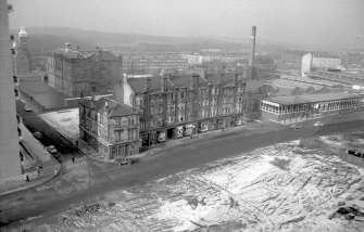 View looking NW showing SE front of Coop buildings with tenement and public house on left and school in background