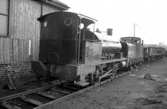 View showing locomotive no.13 (NCB) with diesel and trucks in background