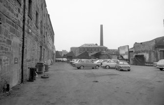 View looking WNW showing part of NNE front of central (N) block of ironworks with part of mill in background