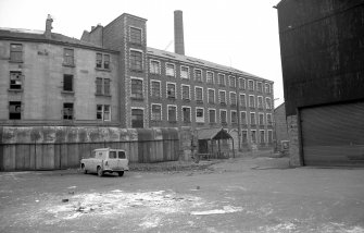 View from SW showing SSW front of main block of mill with part of tenement on left