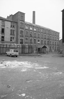 View from SW showing SSW front of main block of mill with part of tenement on left