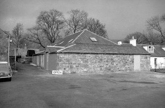 View from SW showing WNW and SSW fronts of E block with waterwheel in background