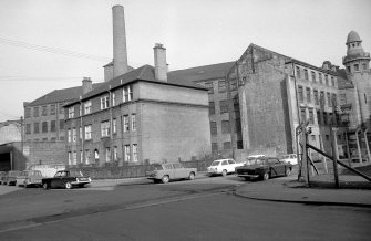 View from SE showing S and E fronts of tenement with works in background