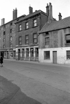 View from E showing SE front of number 27 Waggon Road with part of warehouse in background and part of numbers 21-25 Waggon Road on right