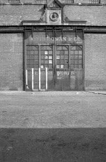 View from WNW showing large ornamental doorway of high single storey block. Rowan and Co Ltd, Elliot Street, Glasgow.