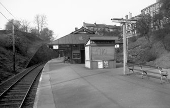 View from SW showing part of SSW front of platform building with newsagent building in foreground