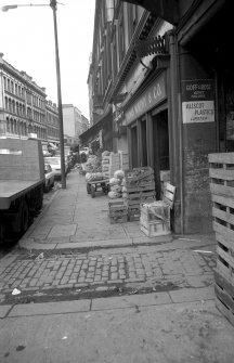 View looking E along Ingram Street with warehouse in background and fruit market on right