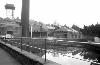 View from SSW showing cooling pond with base of chimney and part of works in background