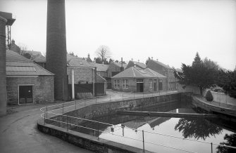 View from SSW showing curling pond with base of chimney and part of works in background