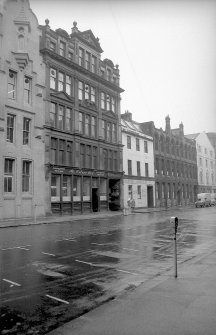 View from N showing WNW front of 106 Brunswick Street with warehouse in foreground and numbers 96-104 Brunswick Street in background