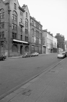 View from SSE showing ESE front of warehouse with numbers 23-25 in background