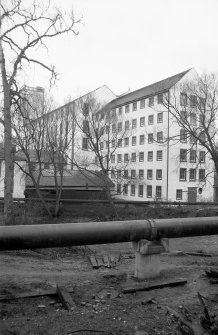 View from N showing NW and NE fronts of 'Old End' with newer block in background