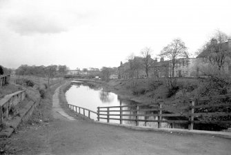 General view looking E showing canal at Luggiebank Road