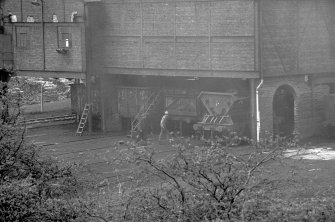 View from ENE showing trucks being loaded with coal from E block