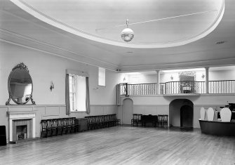 Interior-general view of St Cecilia's Hall, Edinburgh, showing gallery and large oval mirror over fireplace.