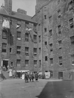 General view of Milne's Court, Edinburgh, with children standing in the centre.