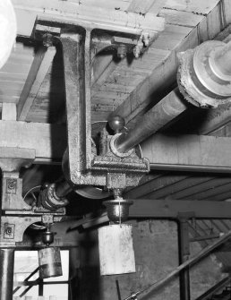 Detail of lineshaft bearing and shaft on suspended cast-iron ceiling bracket on 3rd floor of mule mill, providing overhead lineshaft drive for mules, Dangerfield Mills, Hawick. Digital image of B/56505.