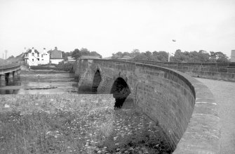View from WNW showing N front of old bridge with hotel in background and part of railway bridge on left