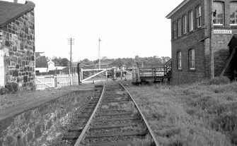 View looking ESE showing level crossing with part of booking office on left and signal box on right