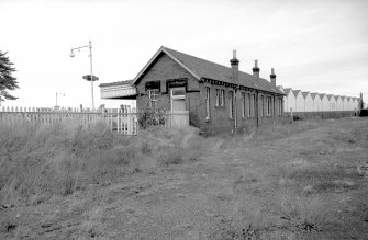 View from SSW showing SW and SE fronts of W building with platform shelter in background