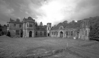 Argyll, Poltalloch House.
General view of entrance fromt and stables facade from South-East.