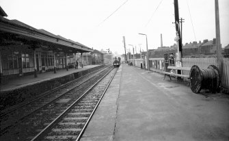 View from ESE showing SSEB locomotive no. 3 approaching with part of down platform building on left