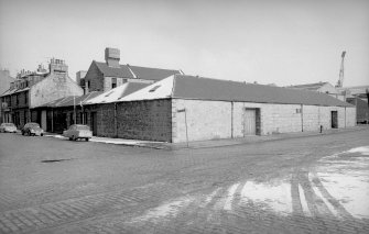 View from SW showing WNW and SSW fronts of stores with numbers 14-18 Wellington Street on left