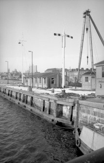 View from SE showing harbour signals on lock with part of sheer legs on right