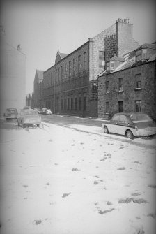 View from SW showing WNW front of S block of mill with number 16 Cotton Street in foreground