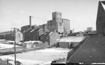 View from WNW showing WSW front of number 12 with numbers 45-49 Cotton Street on left and gas works in background