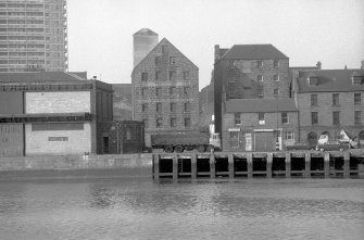 View from SSE showing part of SSE front of sugar refinery with warehouse and numbers 76-78 Regent Quay on right and part of Regent Shed on left