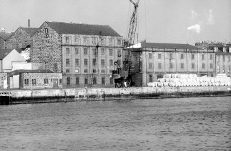 View from SW showing SSW front and part of WNW front of main building with E building on right