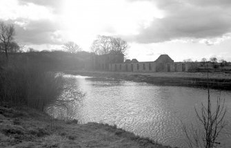 General view from NE showing remains of ESE front of stables and cottages