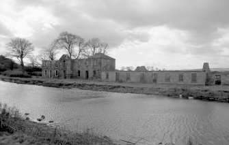 General view from ENE showing remains of ESE front of stables and cottages