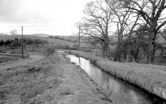 View looking NNW showing canal feeder at Craigmarloch with stables in background