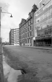 View from SE showing SSW front of warehouse with part of 28-32 Cadogan Street in foreground