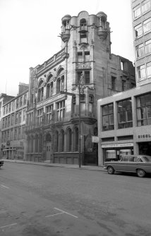 View from SSE showing SSW front of number 64 with numbers 70-72a in background and part of number 58 in foreground