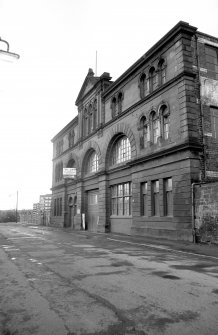 View from SE showing SSW front of number 64 with numbers 70-72a in background and part of number 58 in foreground