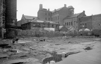 General view from WSW showing part of SSW and WNW fronts of workshop with Abercromby Home in background