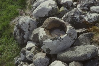 Copy of colour slide showing view of shapeless hollowed stone, said to be a font or holy water stoup,Trumpan Church,Vaternish, Ardmore Bay, Skye.
NMRS Survey of Private Collection 
Digital Image Only