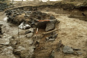 A section through the boat burial with W chamber in the foreground.