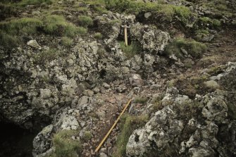 Copy of colour slide showing detail of Tap o' Noth, Grampian  insc: " vitrified mass near south corner near 'cave'. Large transverse channel ( indicated by rule) and holes"
NMRS Survey of Private Collection
Digital Image only