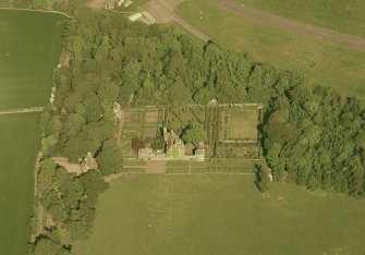 Oblique aerial view of Earlshall country house, formal garden and dovecot, taken from the W.
Scanned image of D 5946 CN.